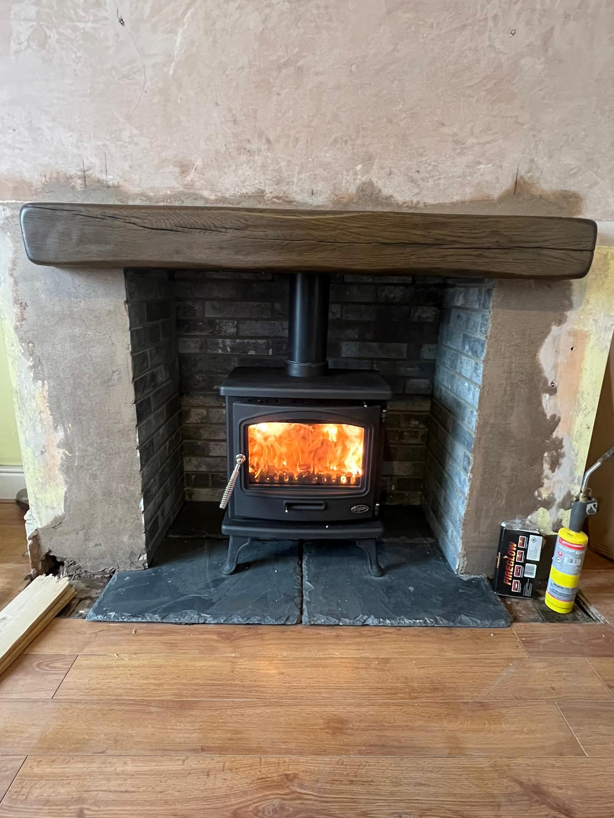 Log burner in stone inglenook