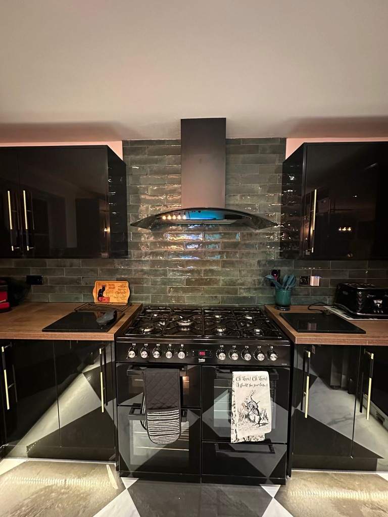 Wren gloss-black kitchen with feature tiling